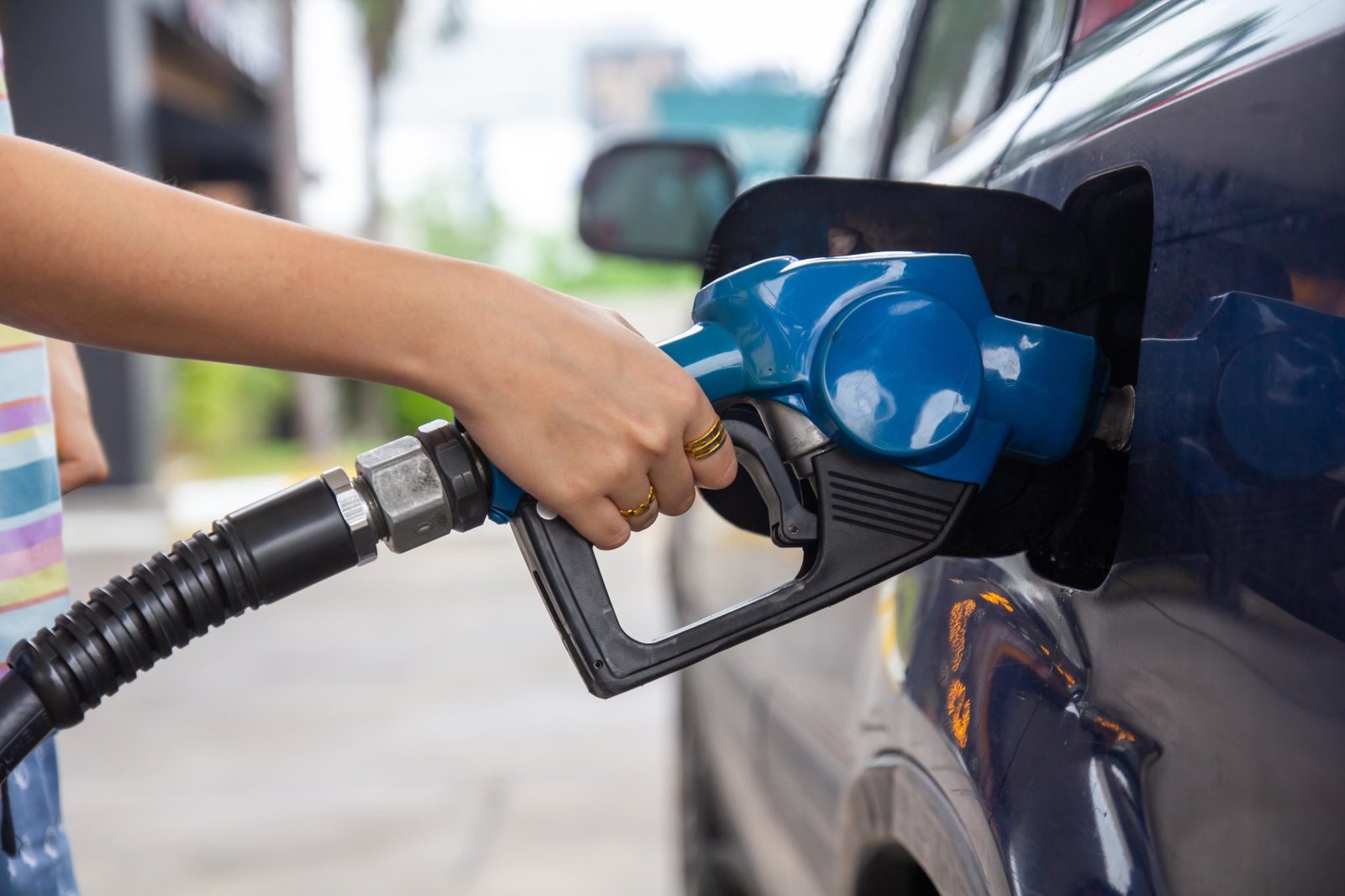 Blue,Car,At,Gas,Station,Filled,With,Fuel.,Closeup,Woman